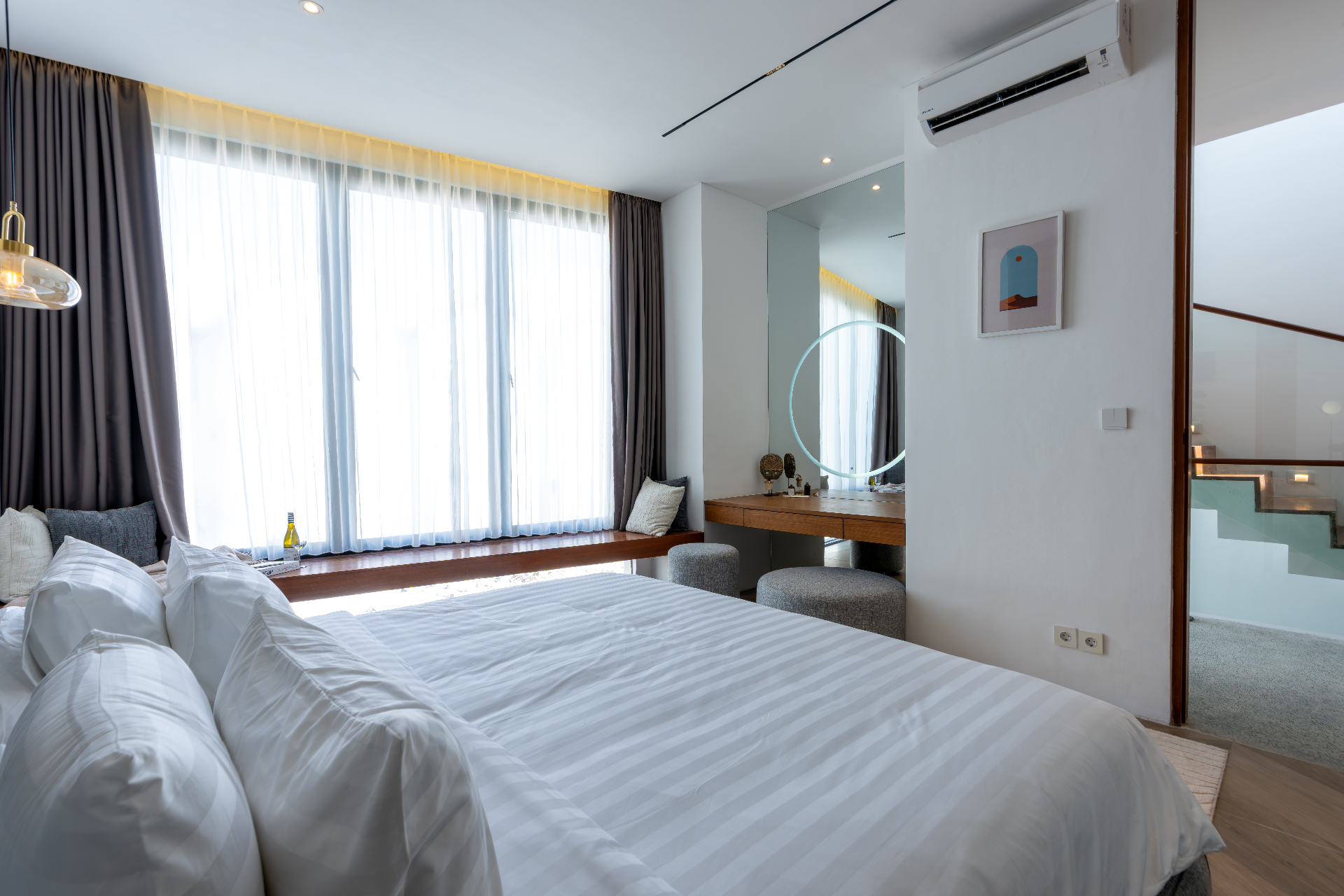 Master bedroom with full-height window and dressing nook