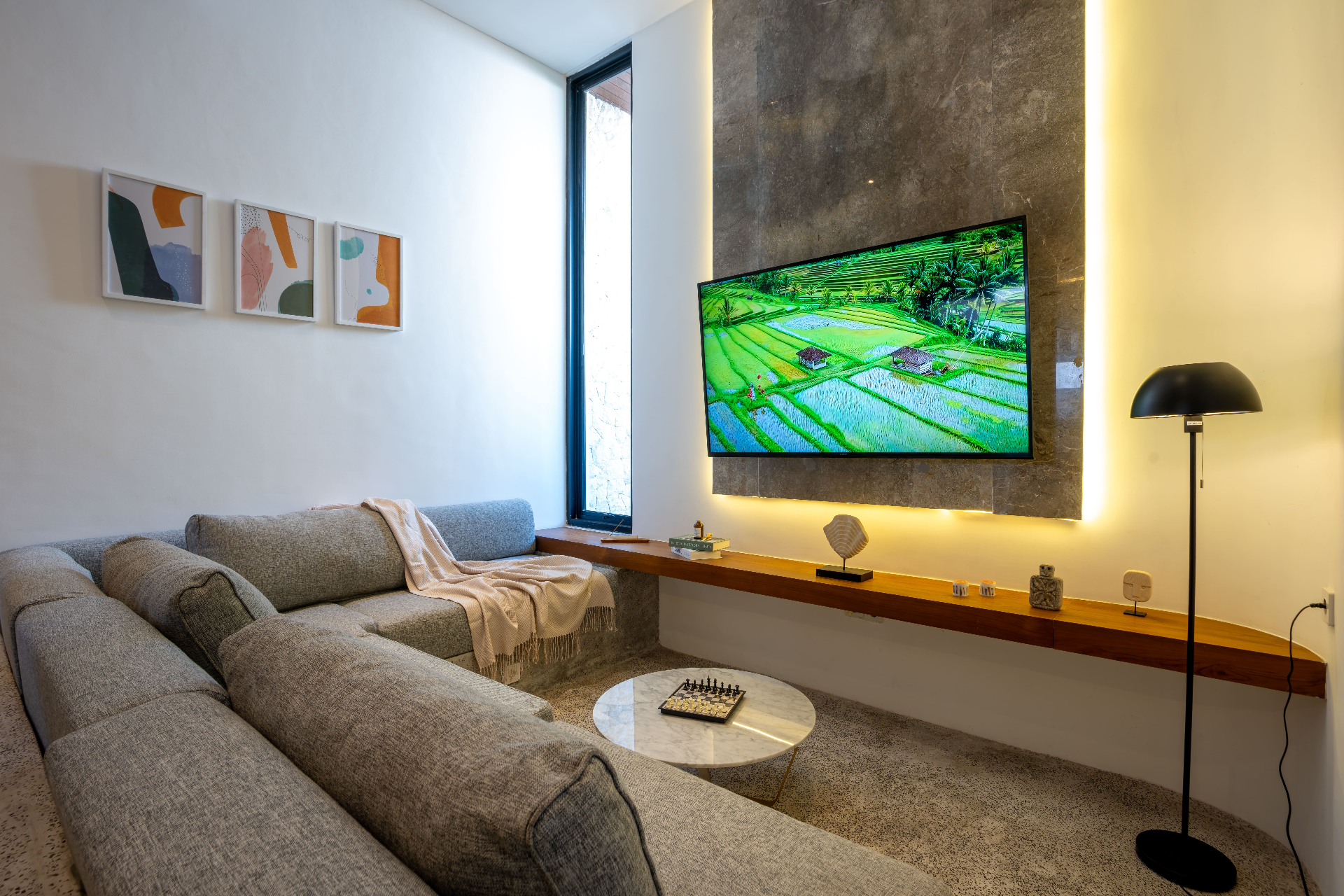 TV lounge with concrete feature wall and gallery