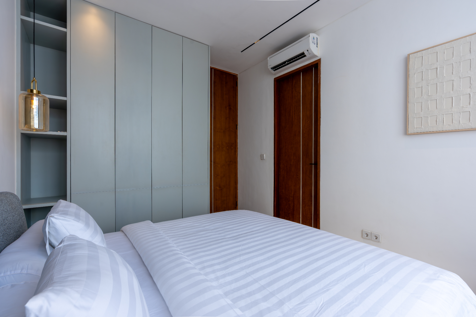 Second bedroom wardrobe in pale-mint joinery