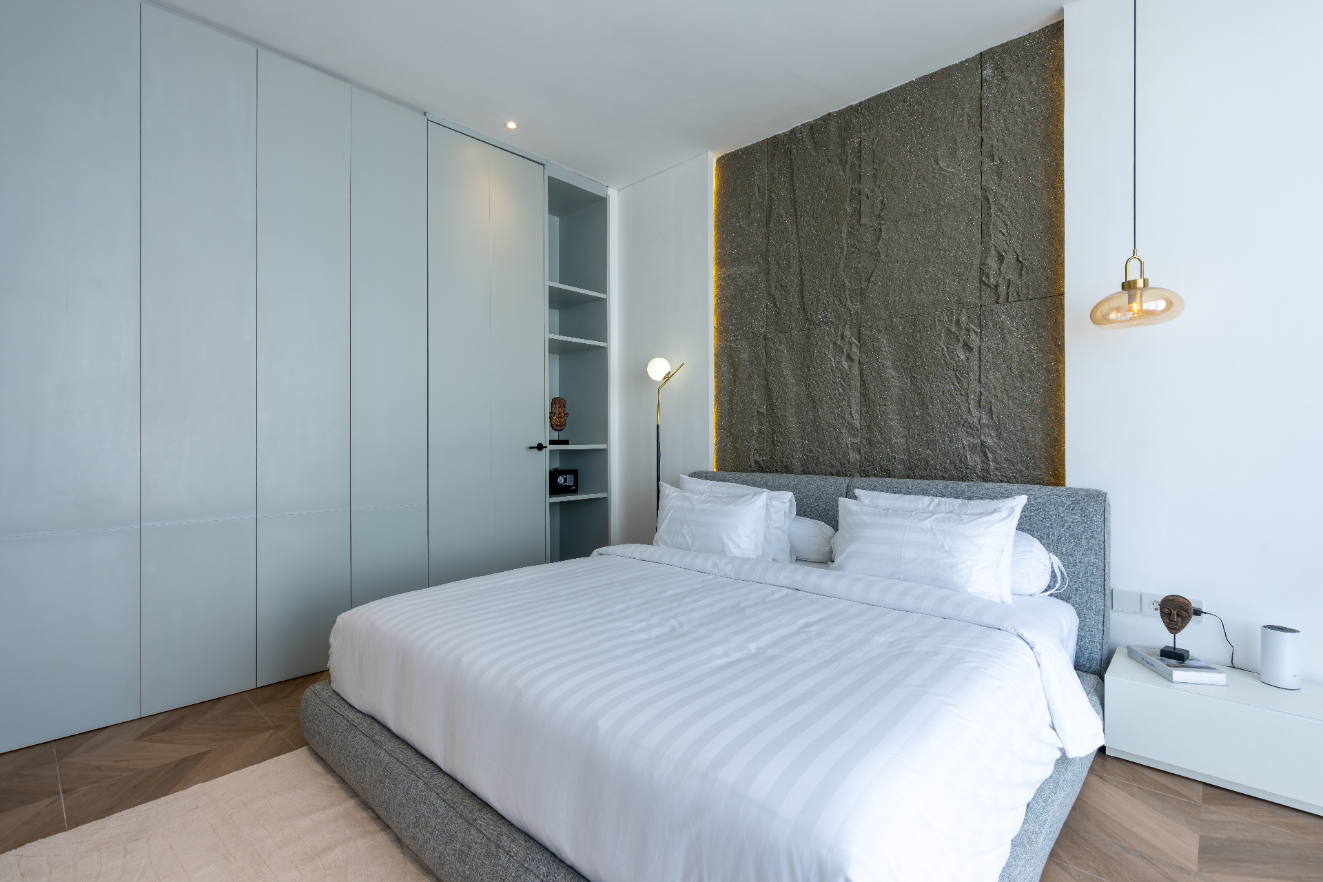 Master bed against the andesite feature wall