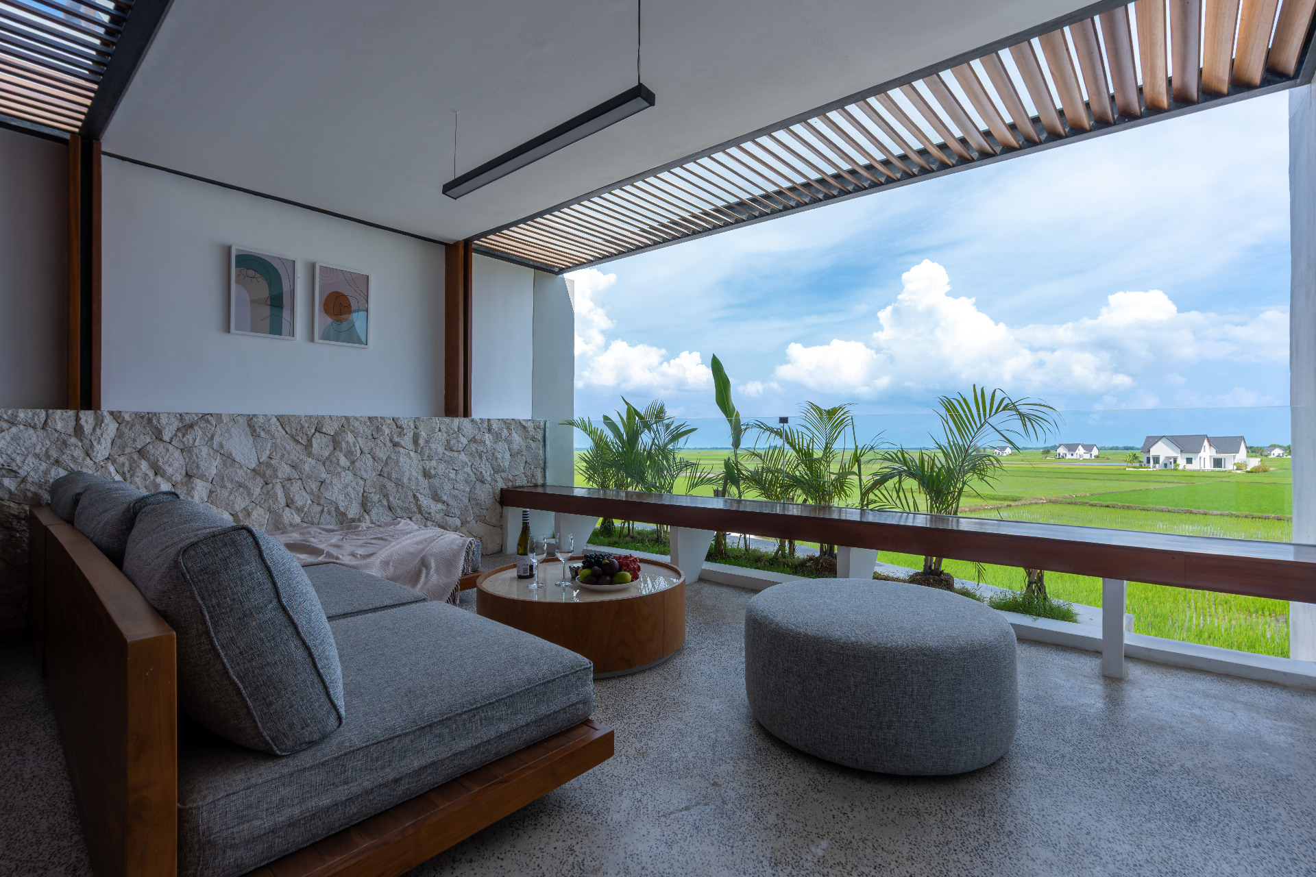 Rooftop terrace with daybed and rice-field view